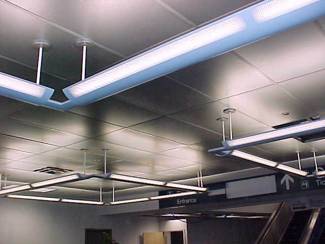 Suspended light integrated with a commercial ceiling