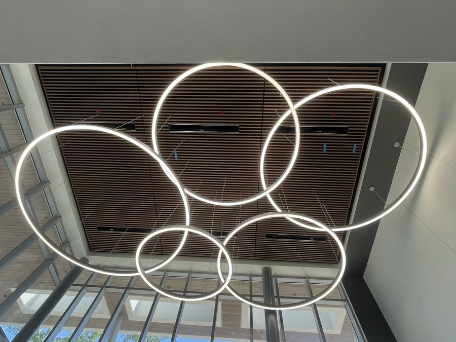 Wide atrium view with suspended circular lighting