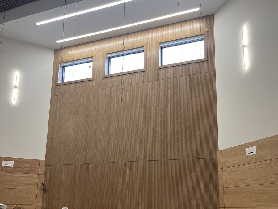 Wood wall panel installation in a high-volume room